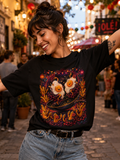 Woman wearing a black T-shirt with a colorful surreal illustration for swimming as flyings, in an outdoor setting.